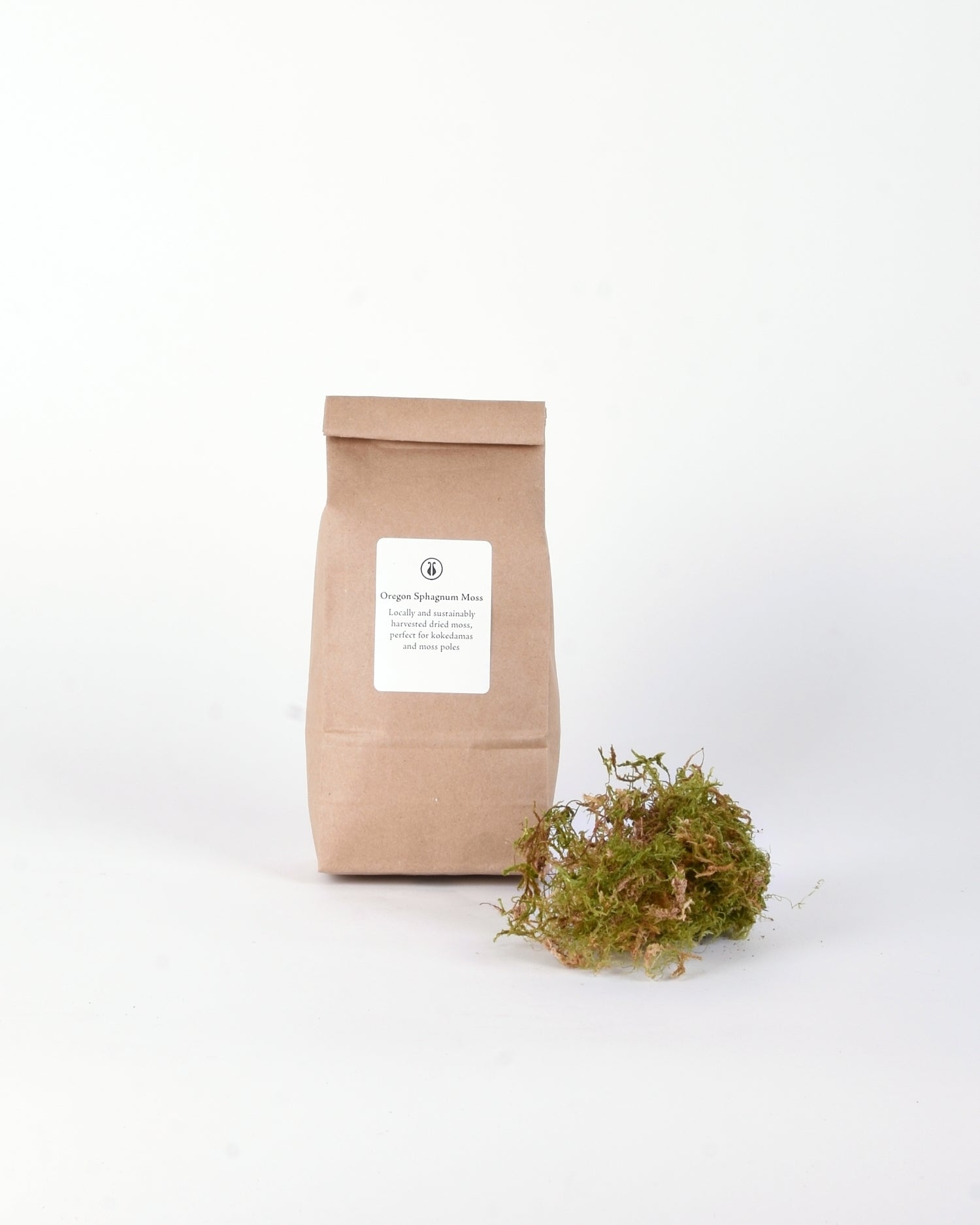 Brown compostable bag with Oregon Sphagnum Moss next to tuft of bright green moss