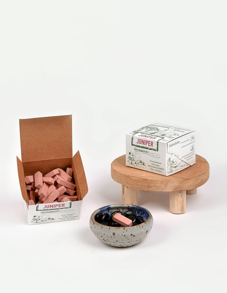 Open Juniper incense box showing pink pill shaped incense blocks 