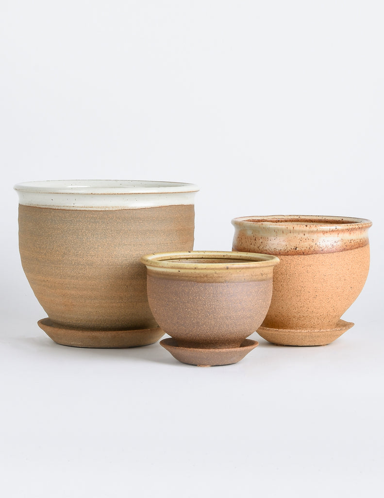 Three stoneware pots varying slightly in natural brown hue with glazed ring around top opening