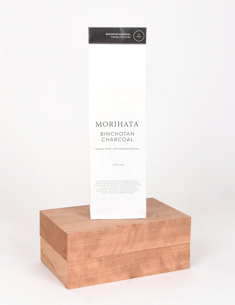 White Bag with black writing "Morihata Binchotan Charcoal" elevated on block of wood