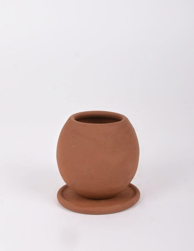 Small round tapered planter in rich dark orange terracotta color with saucer